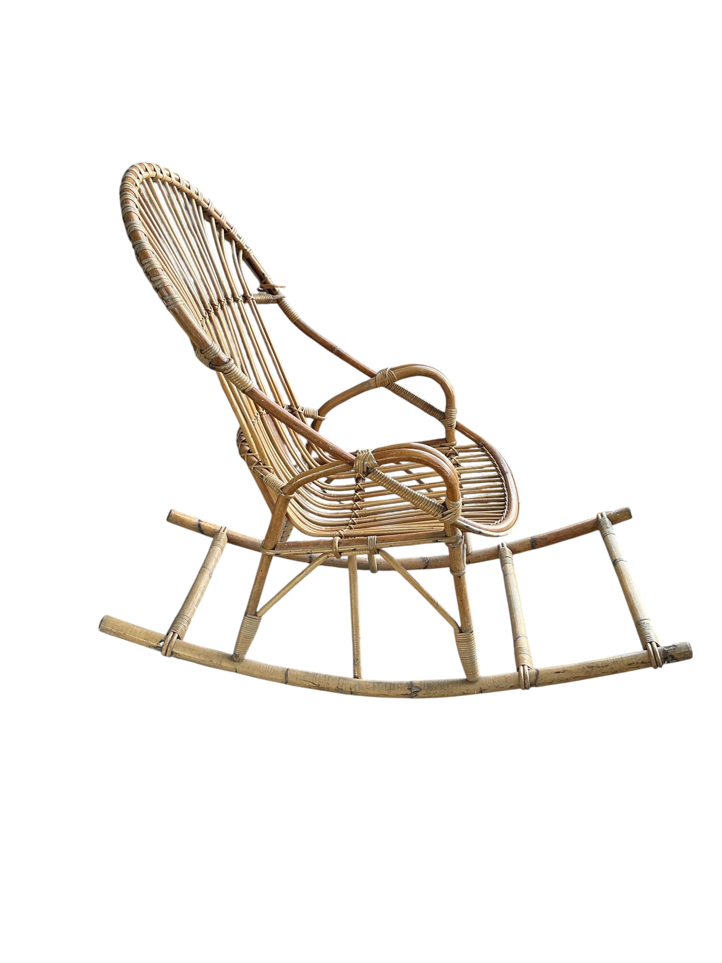 A vintage bamboo rocking chair, width 58cm, depth 125cm, height 100cm
